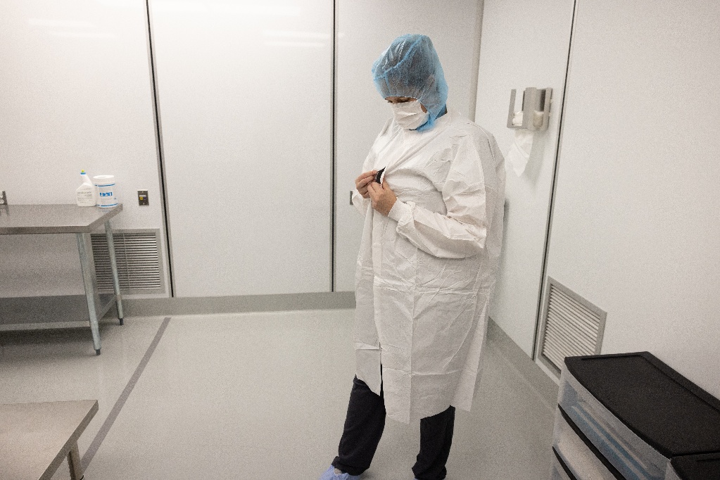 woman buttoning up white garment 