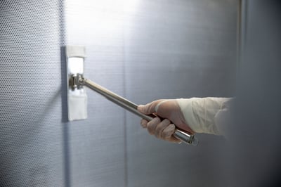 close up of swiffer mop cleaning metal wall